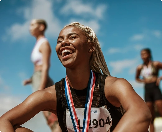 Woman with sports medal laughing